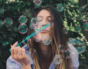 Ways to be happy today - girl blowing bubbles