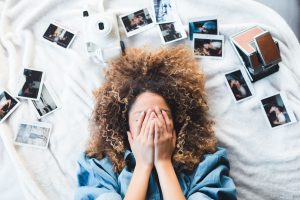 Teenager on bed with photos: how to help teens embrace mindfulness