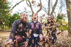 Family playing in leaves: mindful parenting