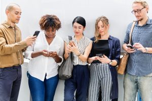 Group of people scrolling on smartphones
